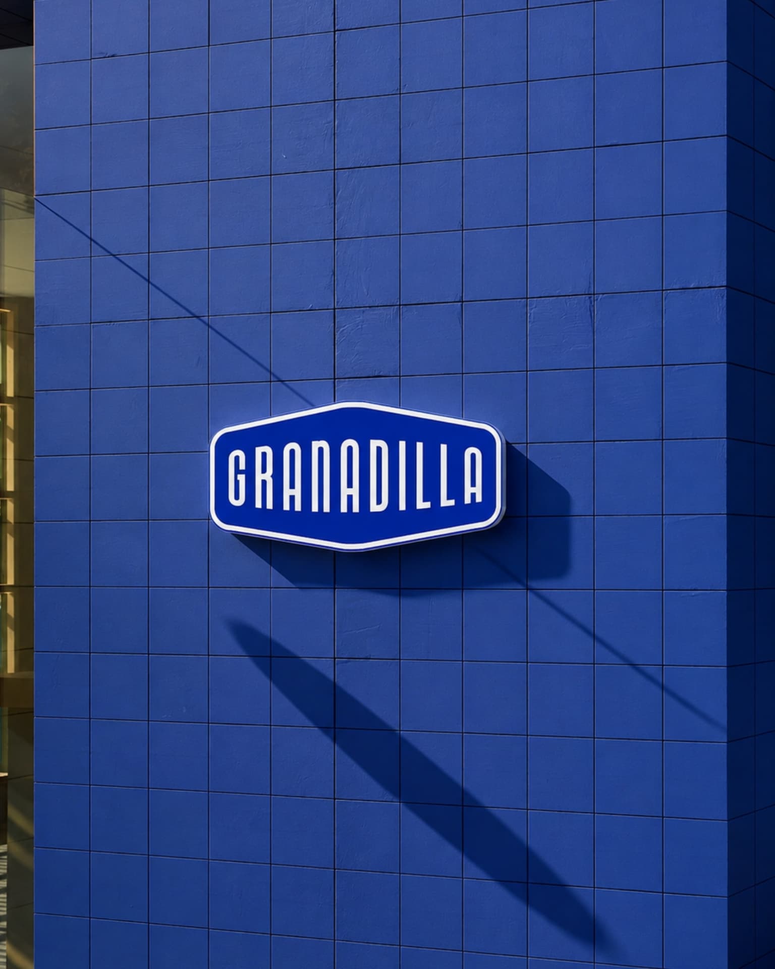 The Granadilla sign mounted on a blue tiled shopfront