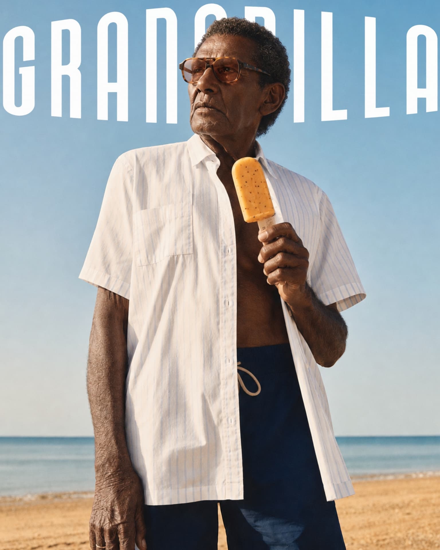Granadilla campaign portrait: a man on the beach with a Granadilla ice lolly beneath the wordmark