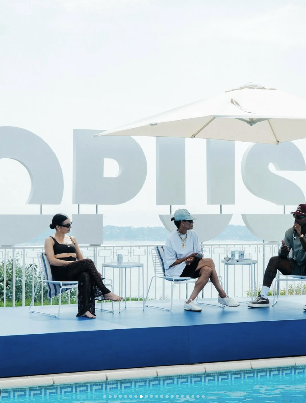 Poolside OPUS panel in front of a large three-dimensional OPUS sign