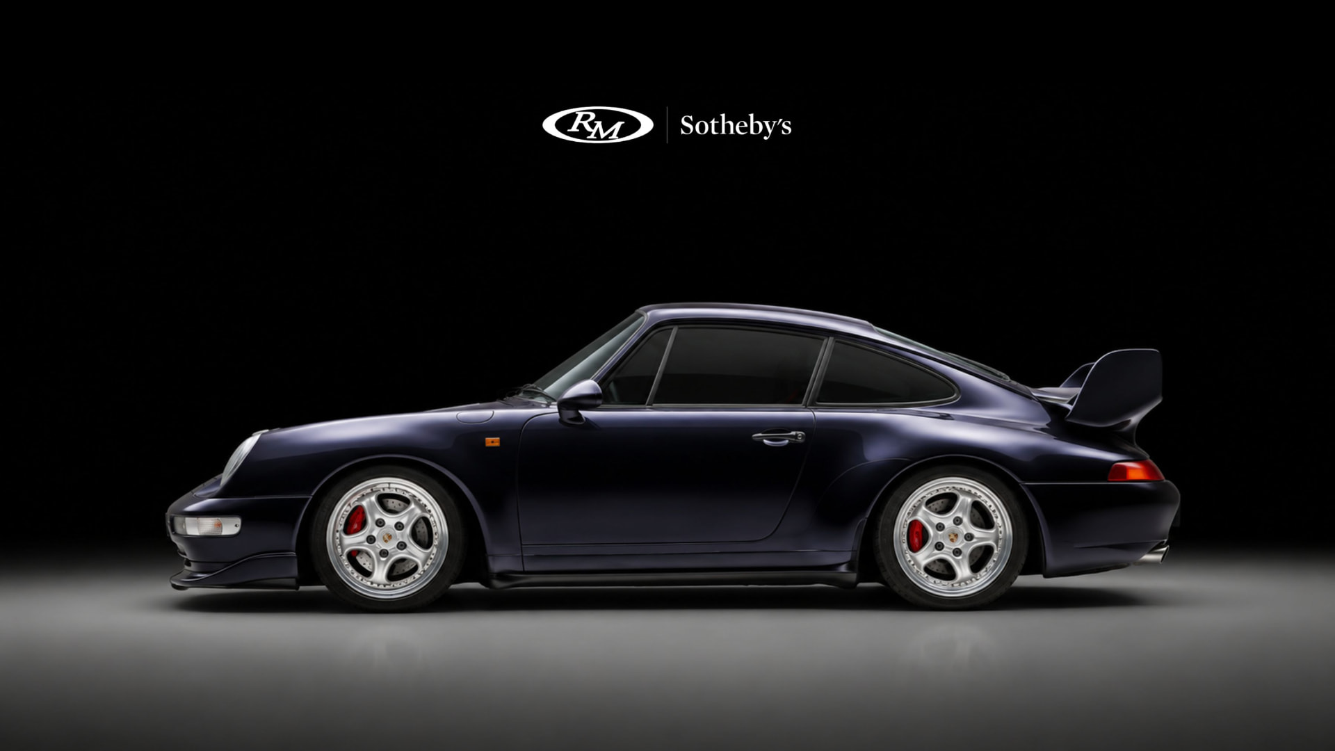 RM Sotheby's Sealed campaign frame: a purple Porsche 911 in profile
