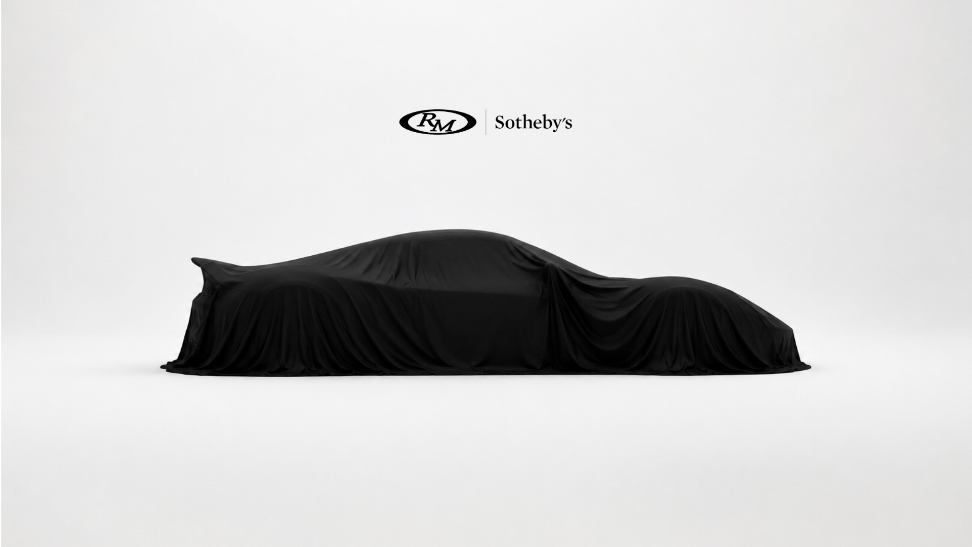RM Sotheby's Sealed campaign frame: a car veiled in black cloth