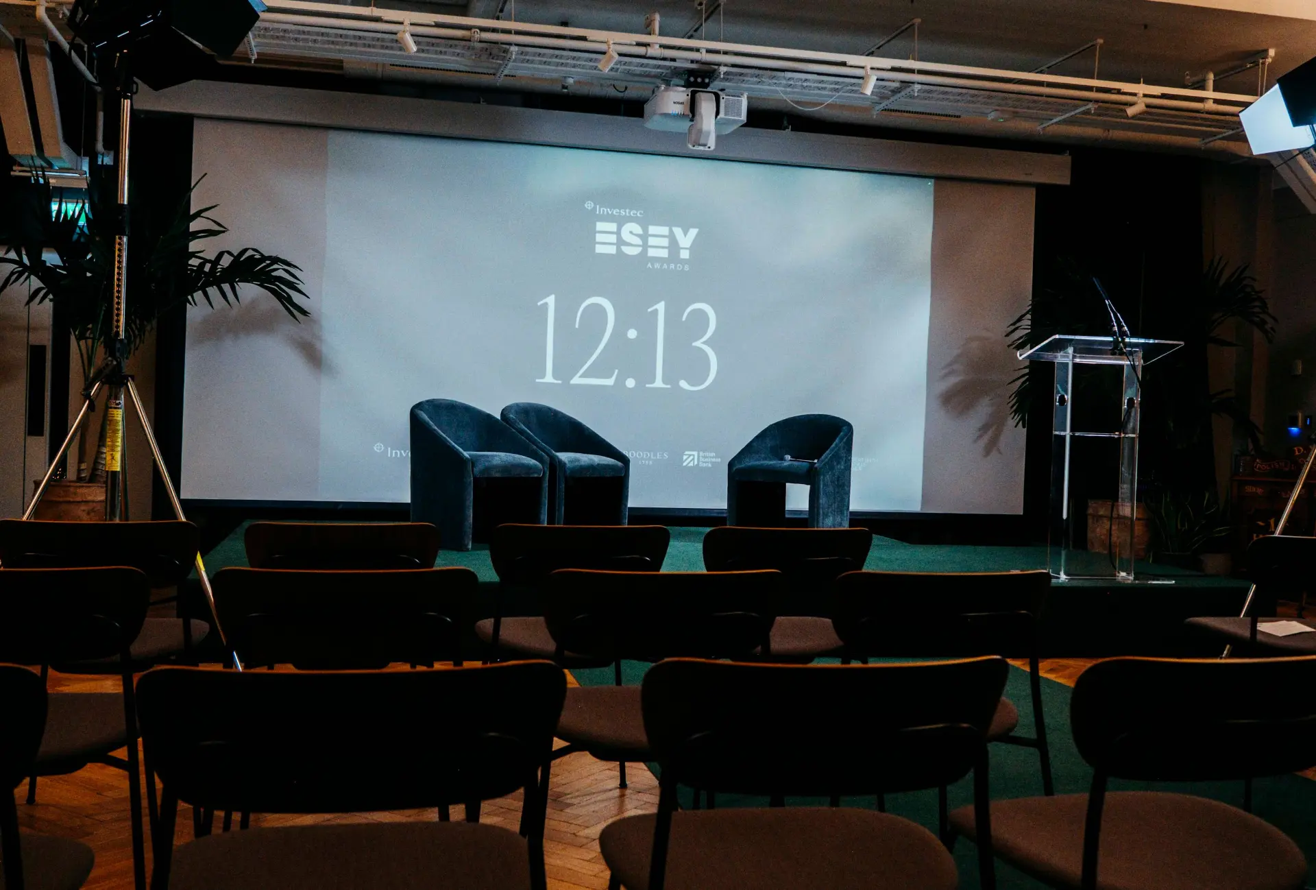 Stage set for the Investec ESEY Awards with an OPUS-hosted screen and empty audience seating