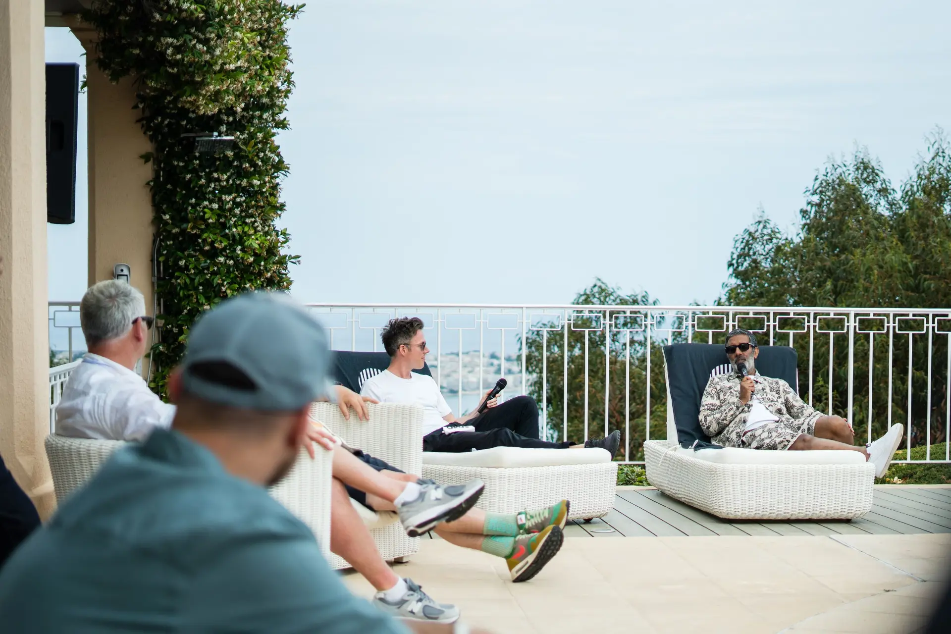 OPUS panel conversation on a sunlit terrace overlooking the sea